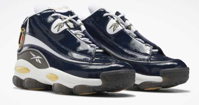 View of navy and white Reebok shoes.